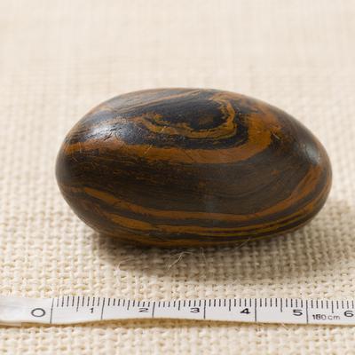 Seer stone associated with Joseph Smith, long side view, with metric tape measure